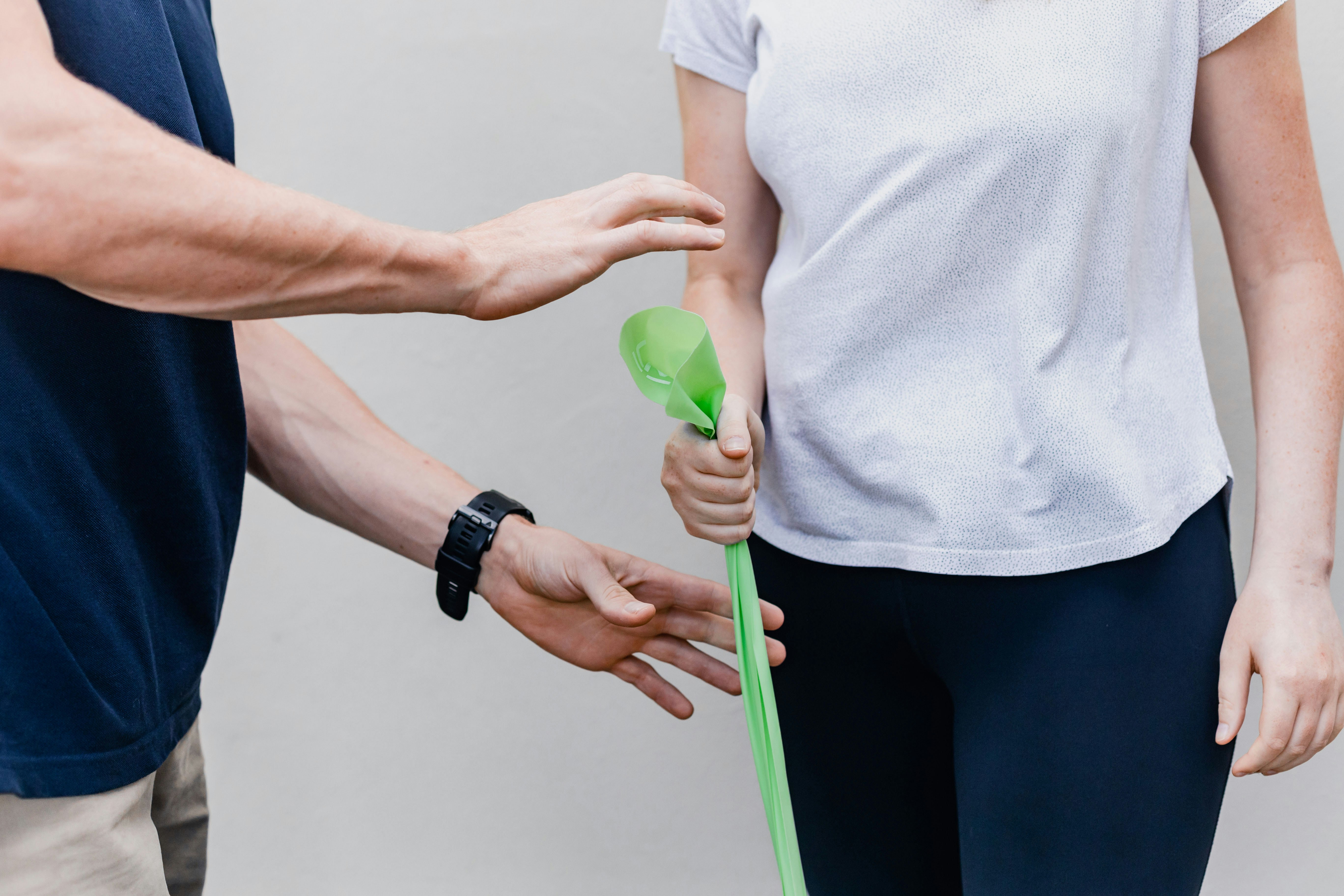 Physiotherapist guiding a patient through a stretch